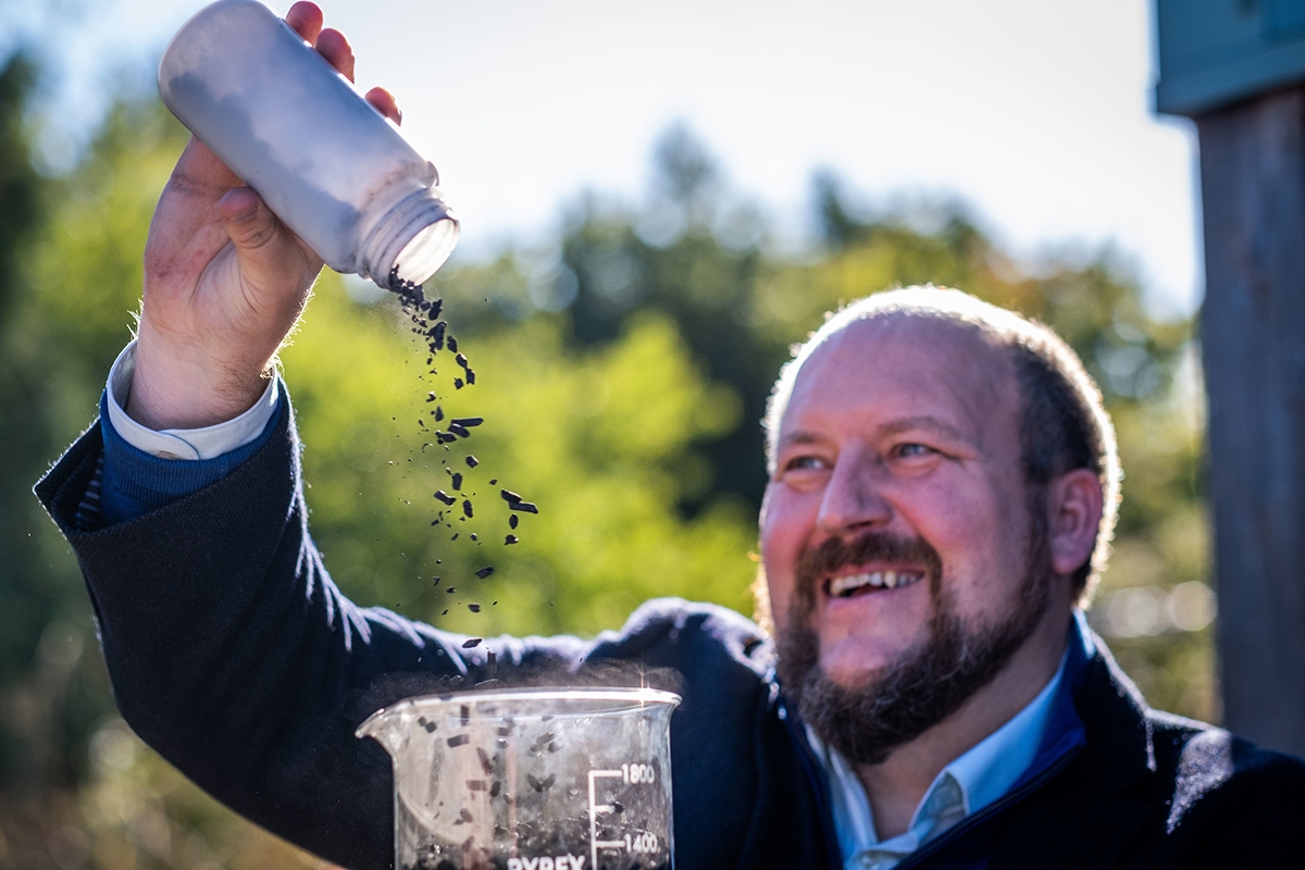 Carbogenics' CEO Professor Ed Craig pouring CreChar pellets