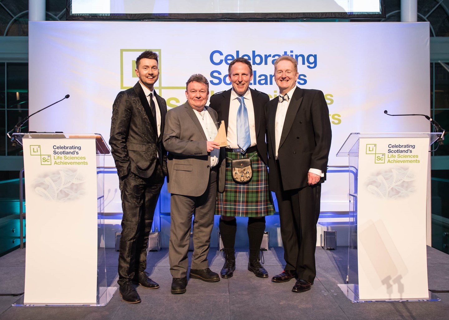Mark Cook, Chair of the Life Sciences Scotland Industry Leadership Group, and STV's Sean Batty with Roslin Technologies' John Clinkenbeard and Joe Lee